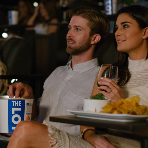 Couples watching a movie at THE LOT at Fashion Island in Newport Beach
