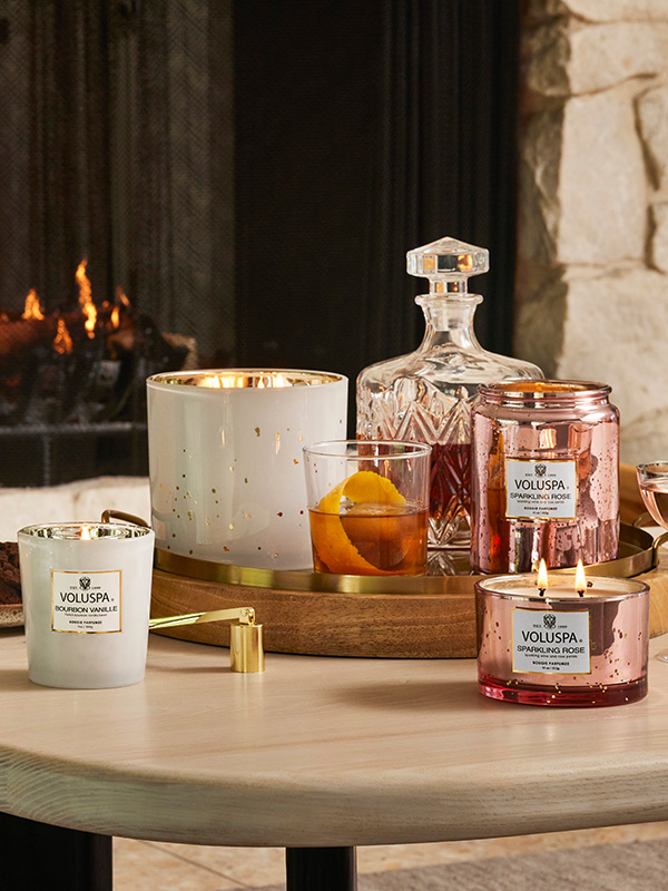 Voluspa candles by fireplace