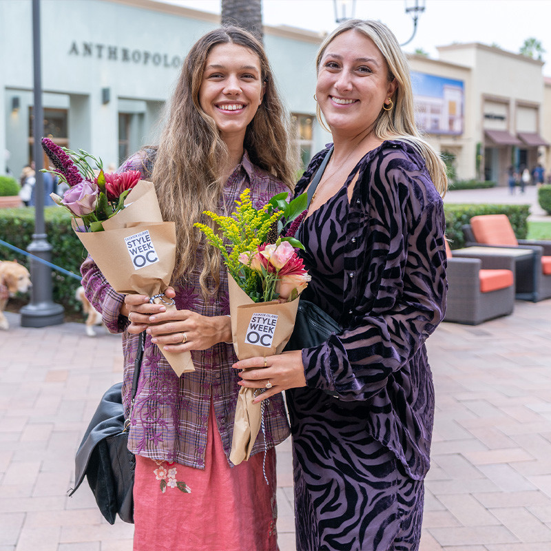 Two girls at StyleWeekOC holding a bouquet