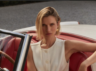 Woman sitting in car wearing Varley