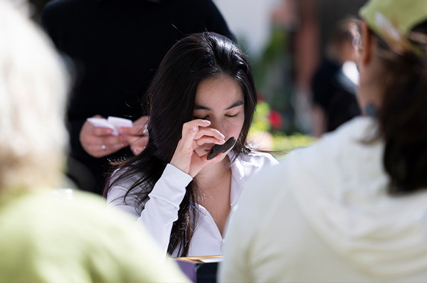 Young woman smelling a scent